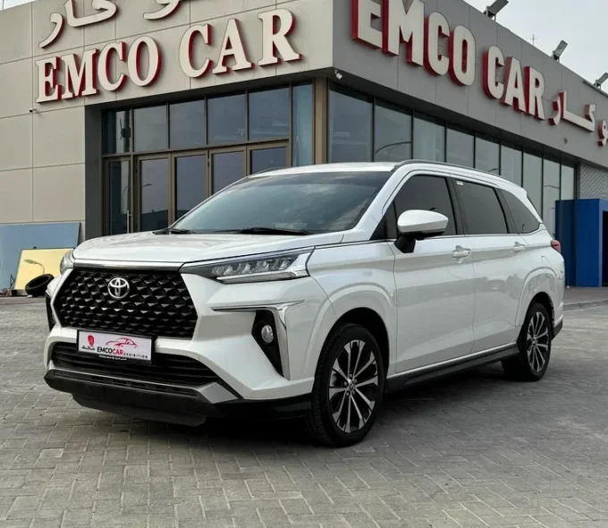 a white car parked in front of emco cars building