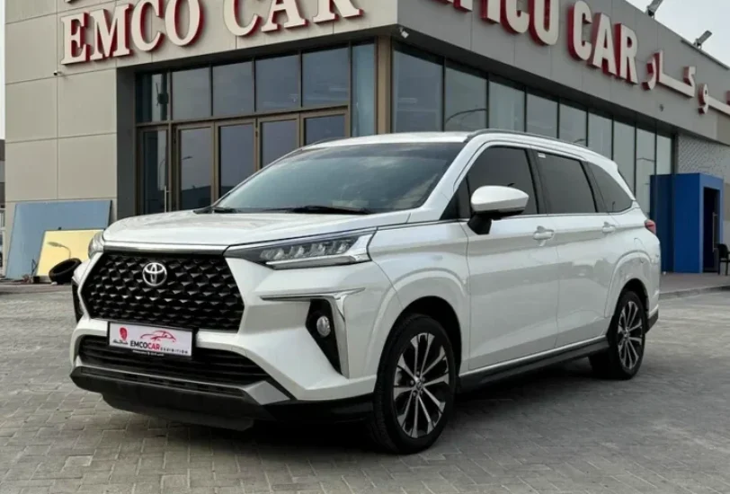 a white car parked in front of emco cars building